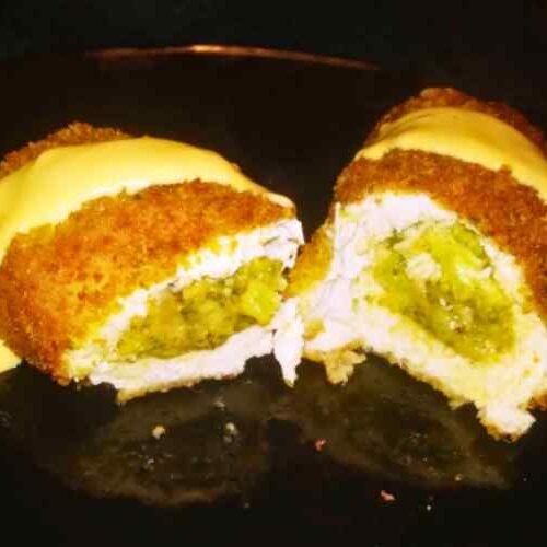Fried Chicken Breast Stuffed with Broccoli and drizzled in cheese sauce