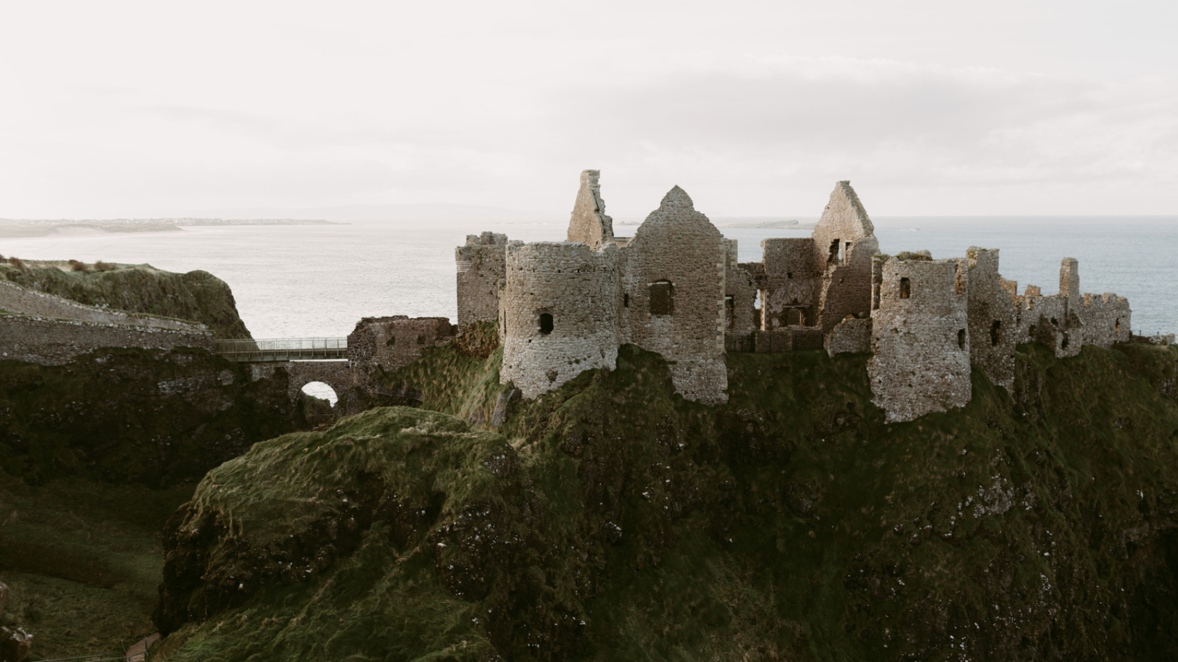 Canva - old medieval ruins of Dunluce Castle on ocean coast in northern Ireland famous place in uk