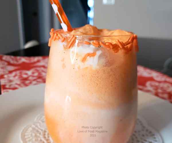 Orange creamy drink with straw
