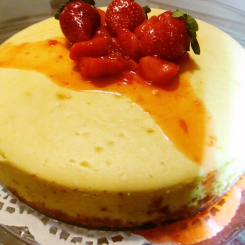 Whole cheese cake drizzled with strawberry topping