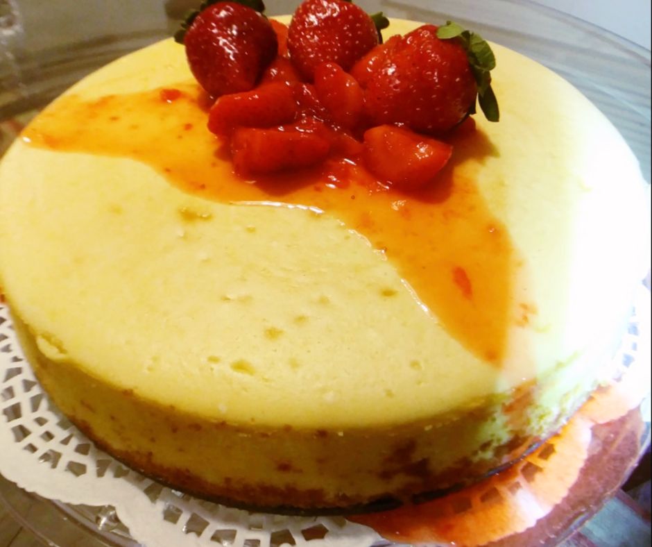 Whole cheese cake drizzled with strawberry topping